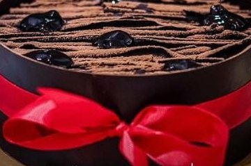 Black forest heart cake with red ribbon