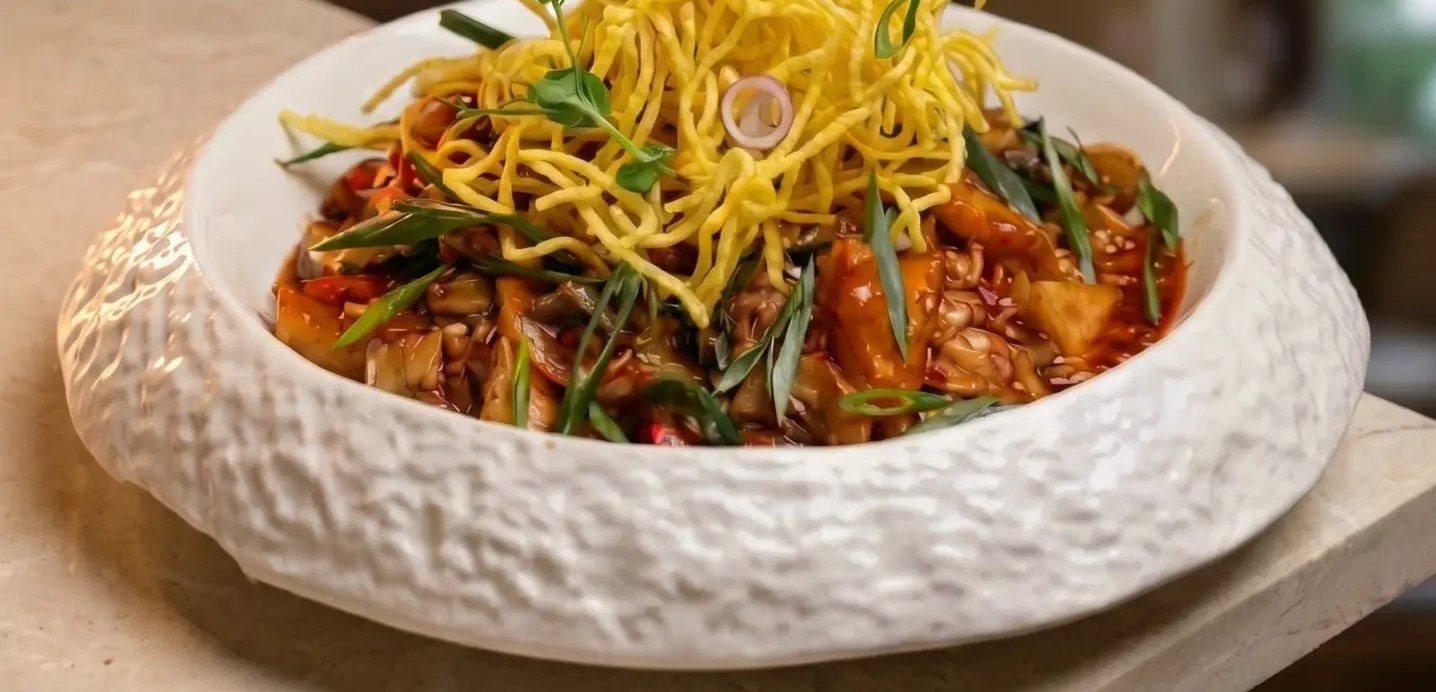 Pan-tossed noodles in a hand-thrown ceramic bowl